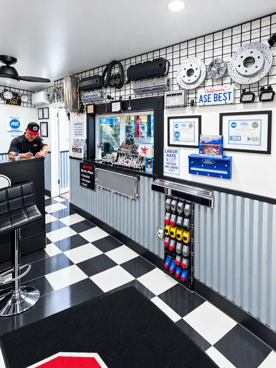 Cedillo's front office with black-and-white checkered floor, service window and parts wall in Fullerton