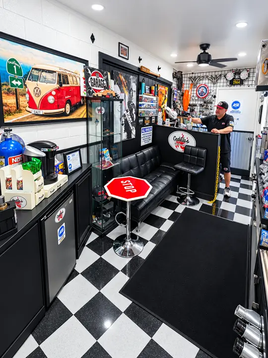 Customer waiting lounge at Cedillo's auto repair with leather seating, checkered floor and coffee station in Fullerton