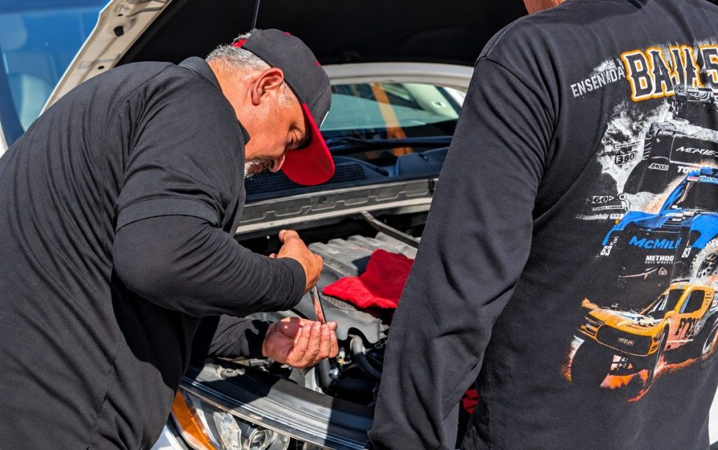 Technician working on an engine with a wrench